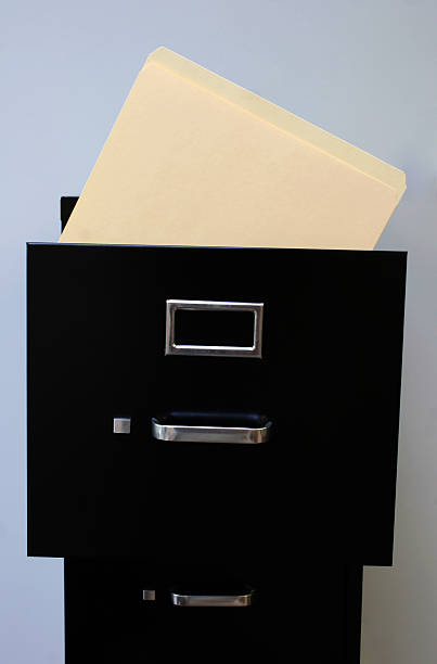istock File cabinet with a manila folder sticking out 172406196