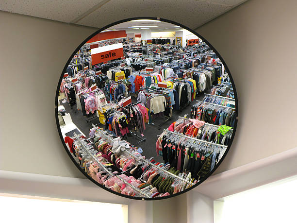 Reflection in store security mirror "Parabolic mirror, existing light view of large clothing store." convex stock pictures, royalty-free photos & images