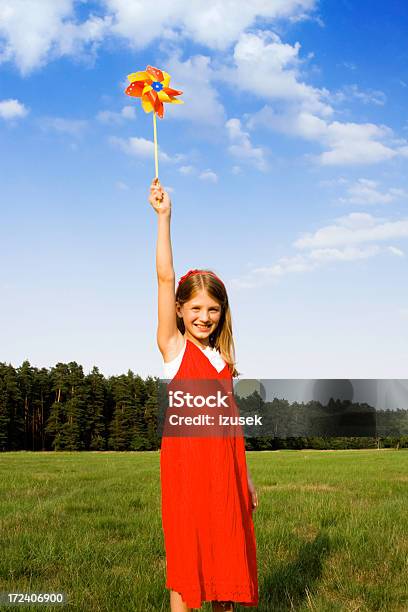 Girl With Pinwheel Stock Photo - Download Image Now - 10-11 Years, Arms Raised, Beautiful People