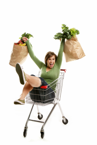 Happy young woman holding her grocery bags