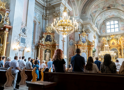 People at the church. Prayer in the Cathedral. Warsaw, Poland - July 30, 2023.