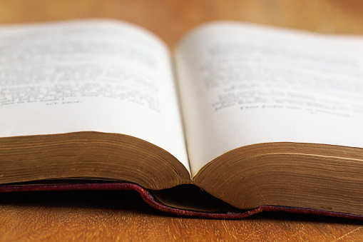 Opened book on the table with pages like heart and flowers