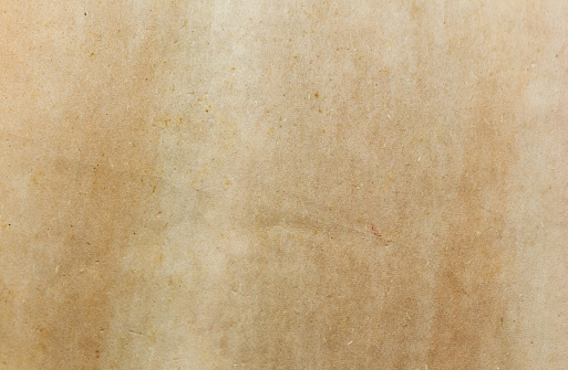 Textured, mottled, yellowed page from an early 20th-century hardcover book, showing its age.