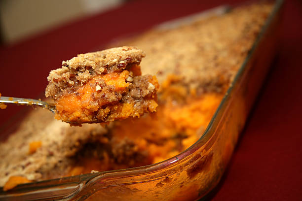 a spoonful of homemade sweet potato crunch - zoete aardappel fotos stockfoto's en -beelden