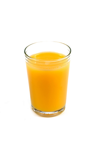 Orange juice in a beautiful juice glass with sliced orange fruits