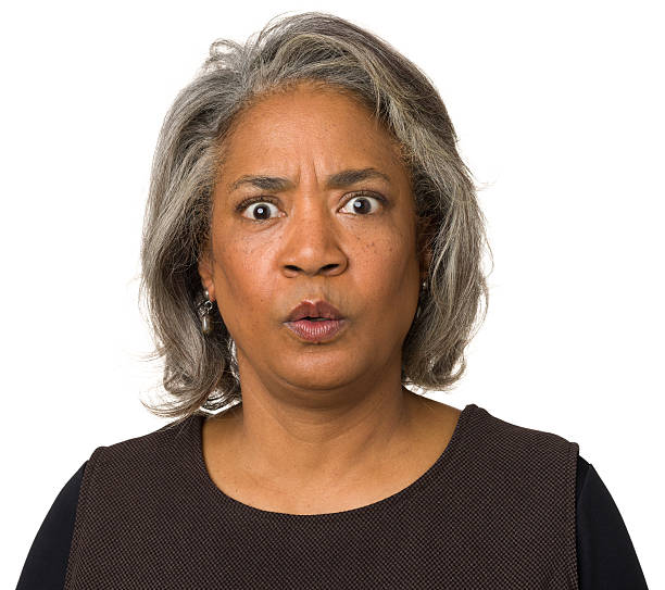 Surprised Worried Mature Woman Portrait of a mature woman on a white background. frowning headshot close up studio shot stock pictures, royalty-free photos & images