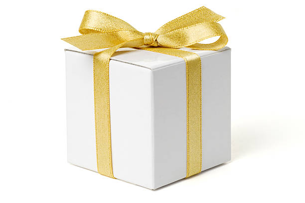White Gift Box with Gold Bow White gift box tied with a gold ribbon bow.  Isolated on white with clipping path. wrapping paper photos stock pictures, royalty-free photos & images