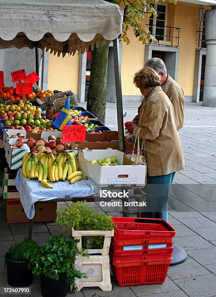 Mature Couple Buying Apples At Farmers Market Stock Photo - Download Image Now - 60-69 Years, 70-79 Years, Adult
