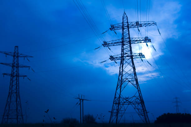 Nightime shot of electricity pylons stock photo