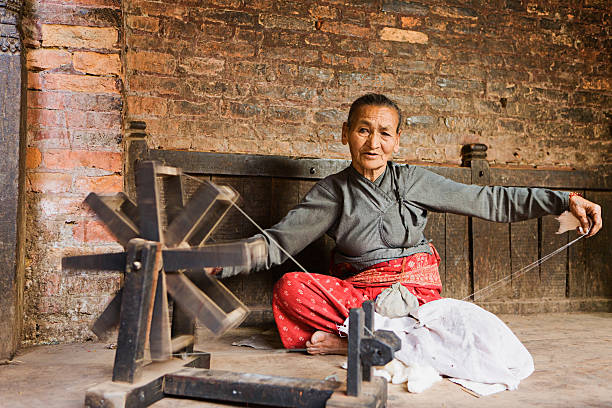 istock Nepali woman spinning the wool 172408134