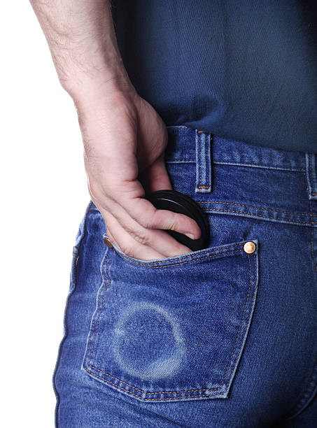 Chewing tobacco Man putting can of chewing tobacco in his back pocket. can bottom stock pictures, royalty-free photos & images