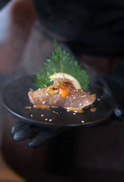 istock Close up hand holding Smoked Sushi 1724084156