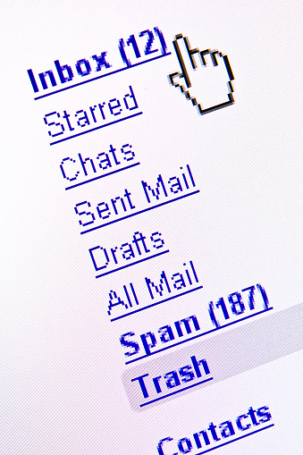 A computer monitor displays Inbox, Spam, and other additional e-mail options.  The cursor is beside the Inbox simulating a user ready to check their new mail.