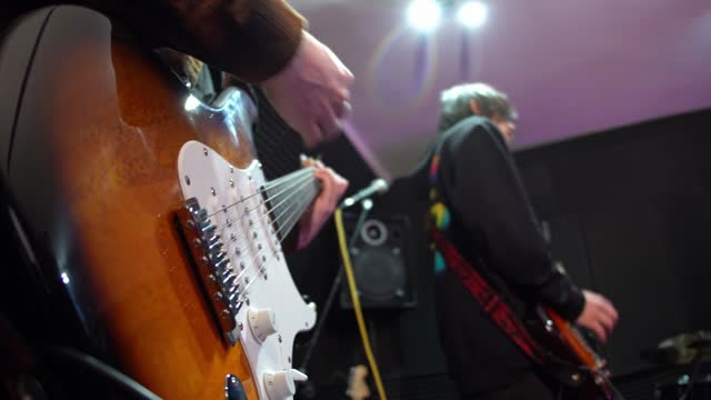 Electric Guitarists Practicing During A Rehearsal In A Studio