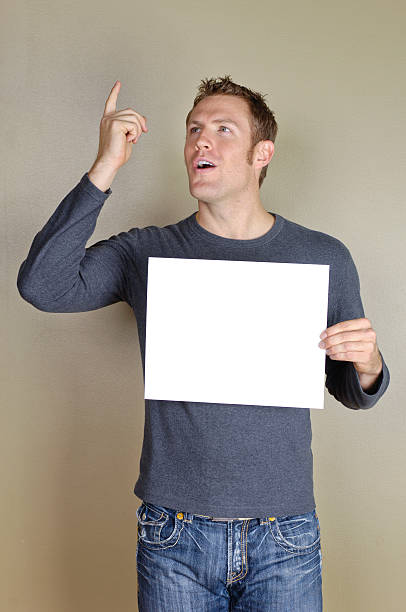 istock Signs - Handsome man holding blank white sign. 172409137