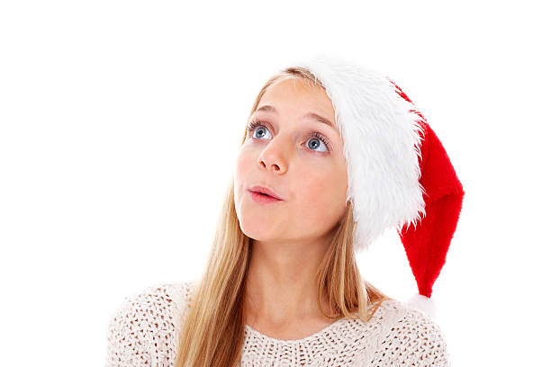 istock Cute little girl wearing Santa hat looking up at copyspace 172409362