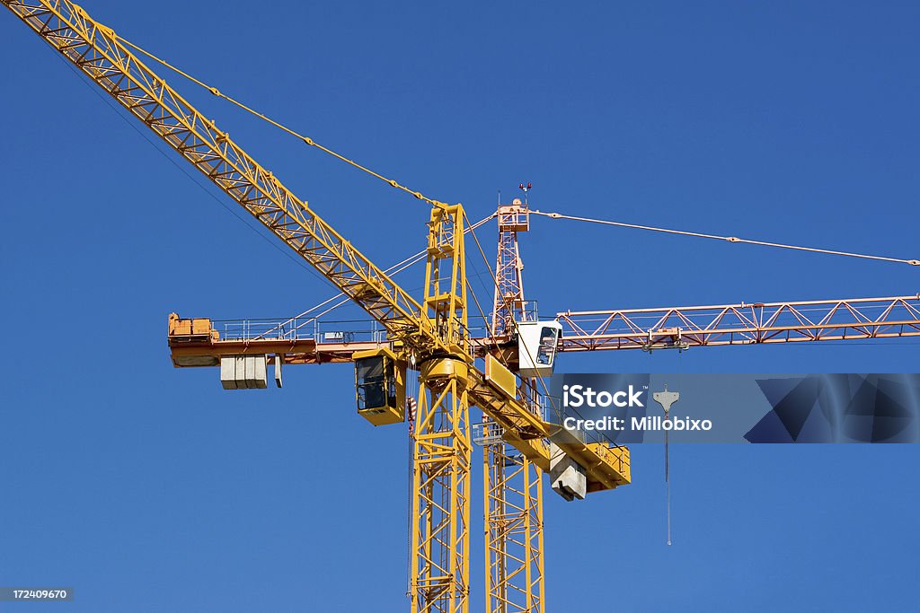 Cranes A view of two mechanical cranes Crane - Machinery Stock Photo