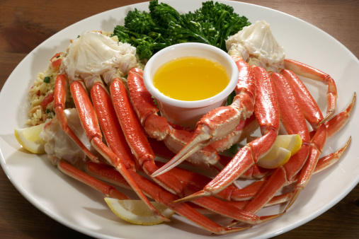 Snow crab legs with herb rice and broccoli.