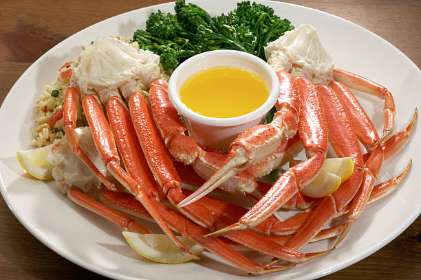 Alaskan snow crab Snow crab legs with herb rice and broccoli. crab leg photos stock pictures, royalty-free photos & images