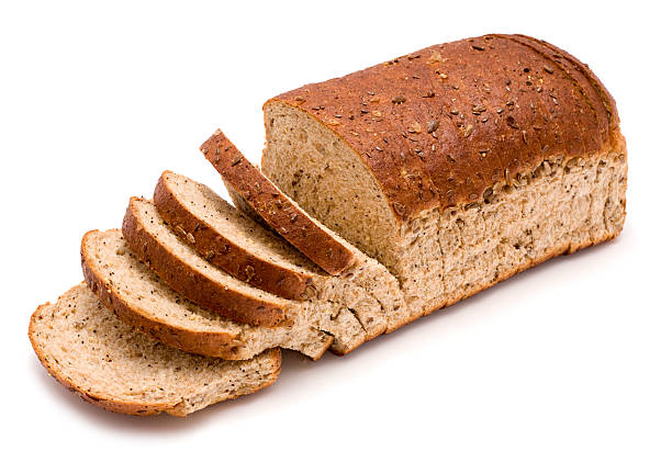 Sliced loaf of wholemeal brown bread on a white background Brown sliced bread on a white background. whole wheat stock pictures, royalty-free photos & images