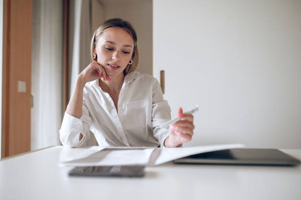 istock Cute blonde young wo,an working with documents 1724102397