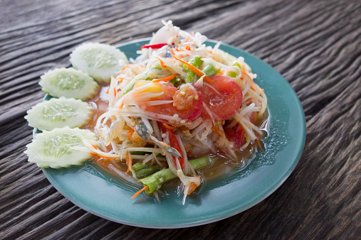 The popular and well-known Thai dish known as 'Somtam Boo' (Papaya Salad with Crab). Here the crab used is a blue sea crab, instead of the traditional freshwater  black crab.