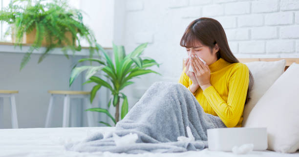 istock woman sick and sneezing 1724110594