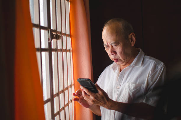 istock Senior Asian man get shocked from scammed on phone 1724113420