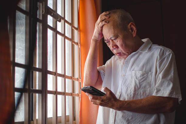 Stressed senior Asian man panic on getting scam