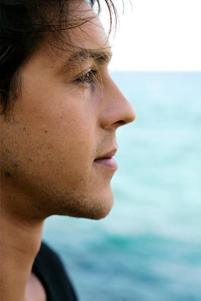 Young man, meditating by the sea.