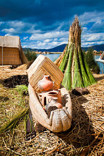 Reed huts and boat on floating Uros Islands on Lake Titicaca in Peru.