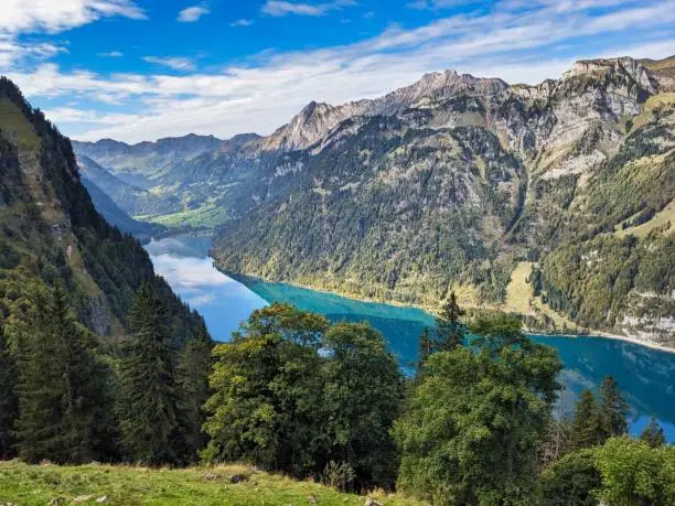 Beautiful mountain lake in the Swiss mountains. Klöntalersee above Nestal Glarus. Wanderlust in autumn. High quality photo