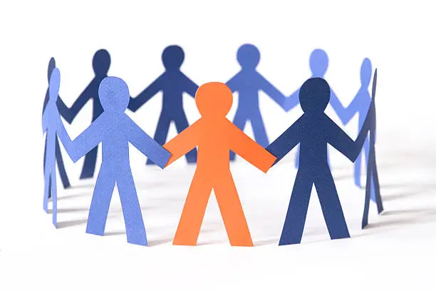 Orange paper person has joined a circle of all-blue paper people. Focus on the orange person. Similar: