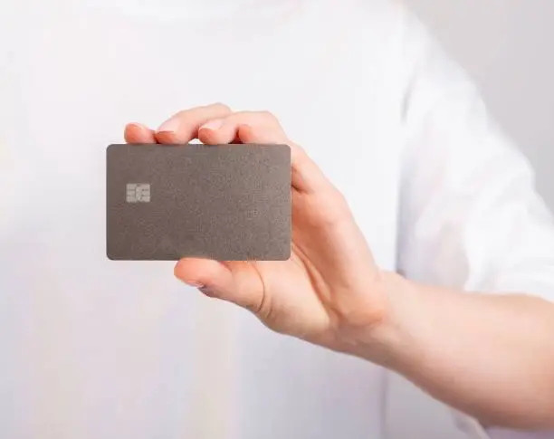 Hand holding bank card mockup, bankcard with chip