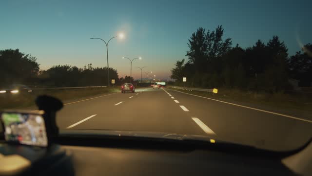 Car Drives Along the Highway at Night.