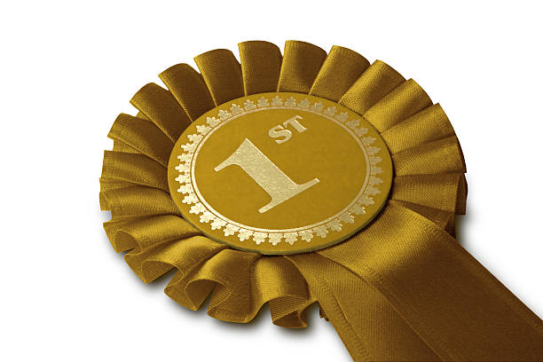 Gold Medal Rosette "Gold Winner's Rosette, with Clipping Path. Isolated on White. See also Silver 2nd Rosette (File 4408813) Bronze 3rd Rosette (File 4424022) http://www.istockphoto.com/file_closeup.phpid=4408813http://www.istockphoto.com/file_closeup.phpid=4424022" gold number 1 stock pictures, royalty-free photos & images