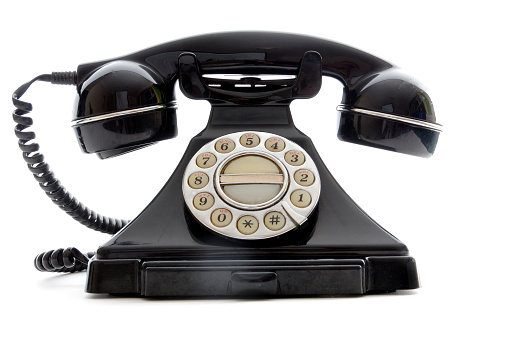 A 3D render of a classic rotary telephone with a cord attached to a telephone on a white background