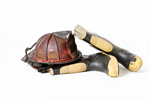 Old Fireman's Helmet &amp; Boots on White Background stock photo