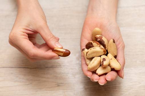 Woman's hand holding brazil nuts