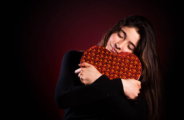 istock Pretty girl holding red heart shaped box 172416148