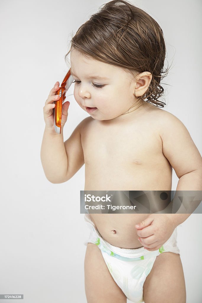 Bambino ragazza con un telefono cellulare - Foto stock royalty-free di Ascoltare