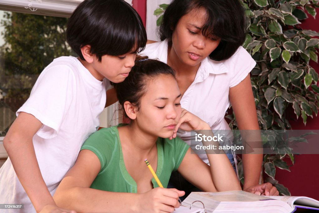 Working Together Family trying to figure out an assignment together. Please view all pictures from this series along with other 10-11 Years Stock Photo