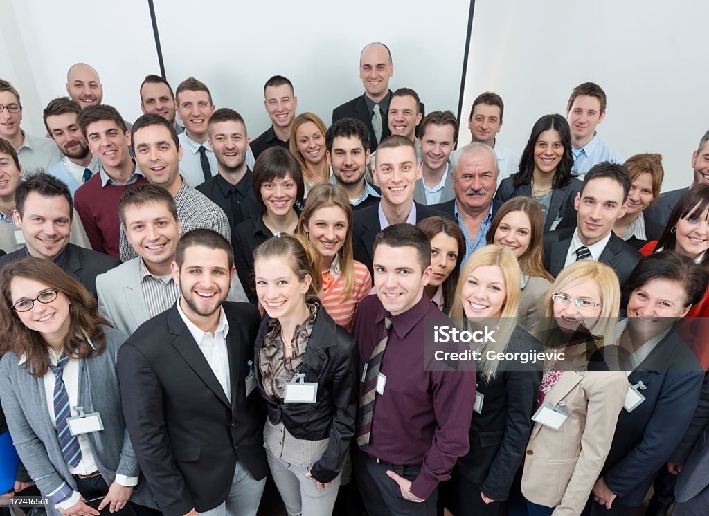 Large group of smiling business people. Business team standing in conference room. Large Stock Photo