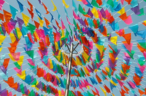 Typical flags in Spain used to decorate streets and squares for an upcoming religious festival (fiesta).