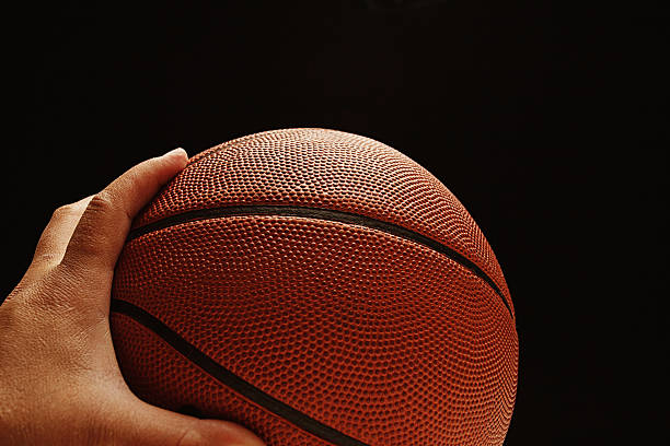 Hand passing the basketball