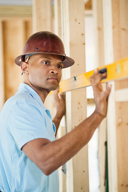 istock Male Architect Examining Level At Construction Site 172417934