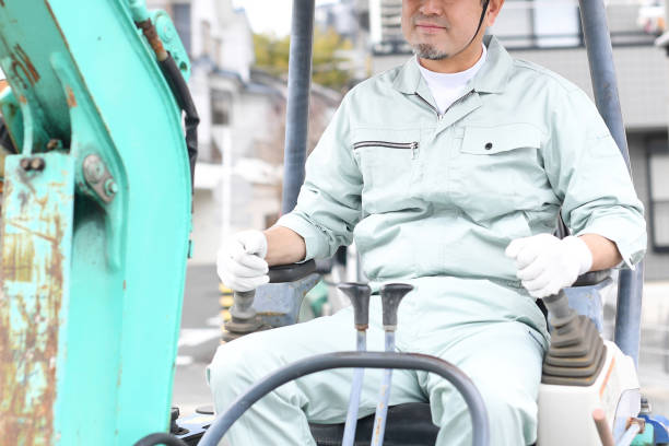 istock Middle-aged Asian male worker operating construction machinery at a construction site 1724180035