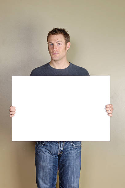 istock Signs - Handsome man holding blank white sign. 172418438