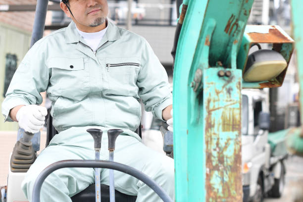 istock Middle-aged Asian male worker operating construction machinery at a construction site 1724185073