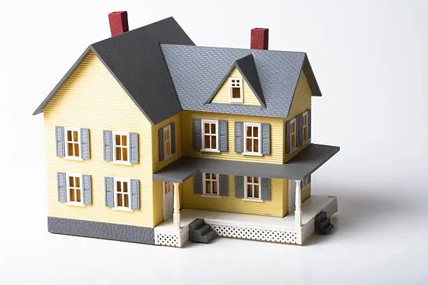 Macro shot of a realistic model house on white background.